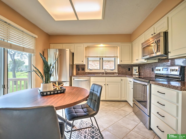 6212 Oak Hills Plz, Omaha, NE 68137 - kitchen with stainless steel appliances, a sink, plenty of natural light, and decorative backsplash