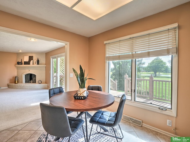 6212 Oak Hills Plz, Omaha, NE 68137 - dining area with light tile patterned floors, baseboards, and a brick fireplace