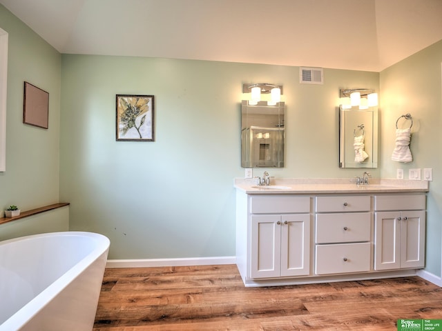 6212 Oak Hills Plz, Omaha, NE 68137 - full bath featuring a freestanding bath, wood finished floors, double vanity, and baseboards
