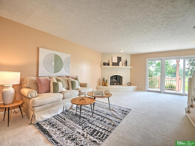 6212 Oak Hills Plz, Omaha, NE 68137 - carpeted living room featuring a textured ceiling and a brick fireplace