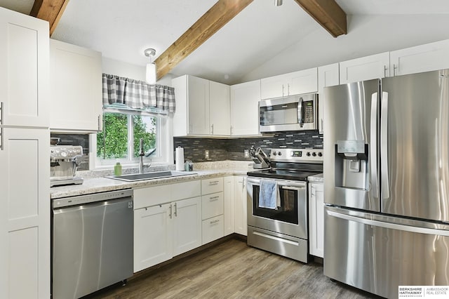 7209 S 132nd Ave, Omaha, NE 68138 - kitchen with appliances with stainless steel finishes, a sink, backsplash, white cabinetry, and wood finished floors