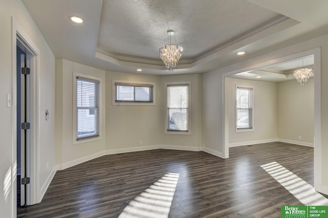 2864 Spaulding St, Omaha, NE 68111 - empty room with a raised ceiling, a chandelier, baseboards, a textured ceiling, and recessed lighting