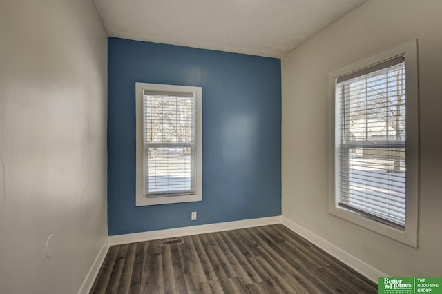 2864 Spaulding St, Omaha, NE 68111 - unfurnished room featuring plenty of natural light, baseboards, and dark wood-type flooring