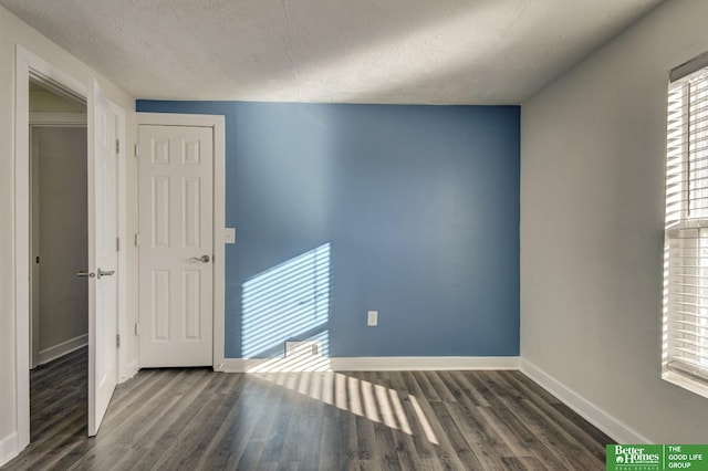 2864 Spaulding St, Omaha, NE 68111 - spare room with a textured ceiling, baseboards, and wood finished floors