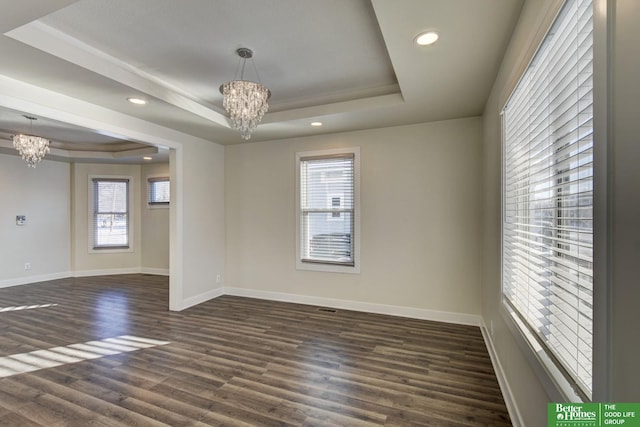 2864 Spaulding St, Omaha, NE 68111 - empty room with a chandelier, a raised ceiling, baseboards, dark wood-type flooring, and recessed lighting