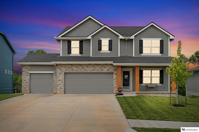 17618 Clay St, Bennington, NE 68007 - view of front of house with concrete driveway, a front yard, a porch, a garage, and brick siding