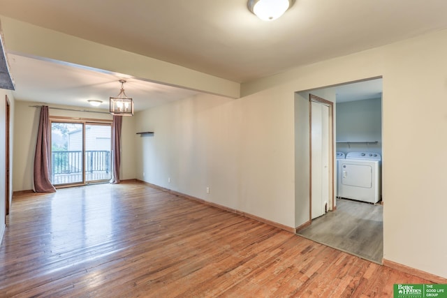 830 N 78th St, Omaha, NE 68114 - empty room with washing machine and dryer, light wood finished floors, a chandelier, and baseboards