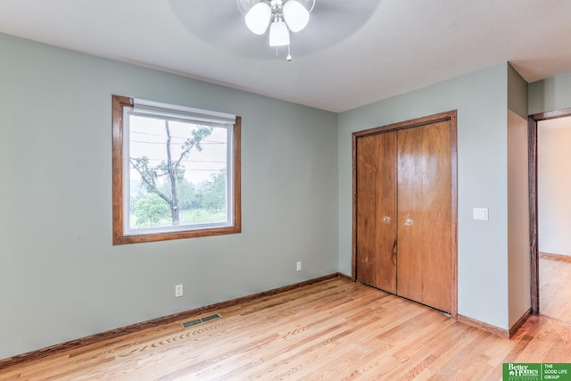 830 N 78th St, Omaha, NE 68114 - unfurnished bedroom featuring light wood-style floors, a closet, baseboards, and ceiling fan