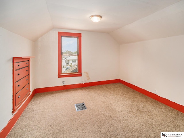 4834 Adams St, Lincoln, NE 68504 - additional living space with lofted ceiling, carpet flooring, and baseboards