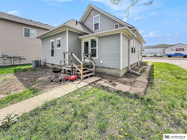 4834 Adams St, Lincoln, NE 68504 - rear view of house with a yard and central AC unit