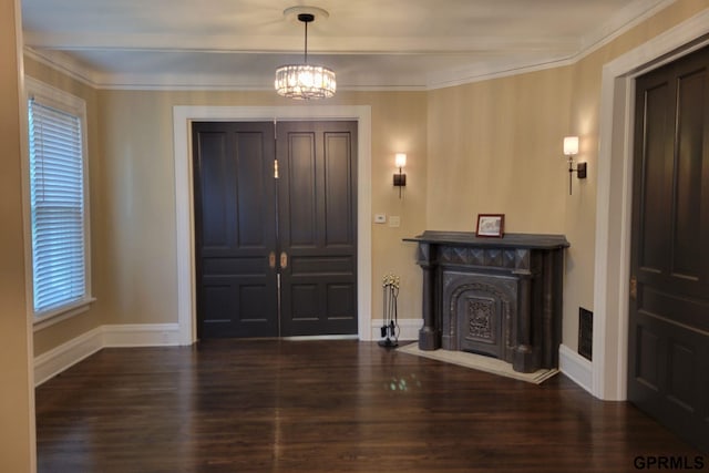 1205 N Broad St, Fremont, NE 68025 - entrance foyer with wood finished floors, baseboards, a chandelier, plenty of natural light, and ornamental molding