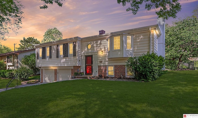 1439 S 123rd St, Omaha, NE 68144 - bi-level home with an attached garage, a lawn, brick siding, and a chimney