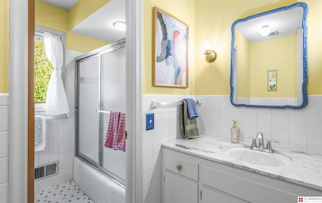 1439 S 123rd St, Omaha, NE 68144 - full bathroom with tile walls, vanity, combined bath / shower with glass door, and wainscoting