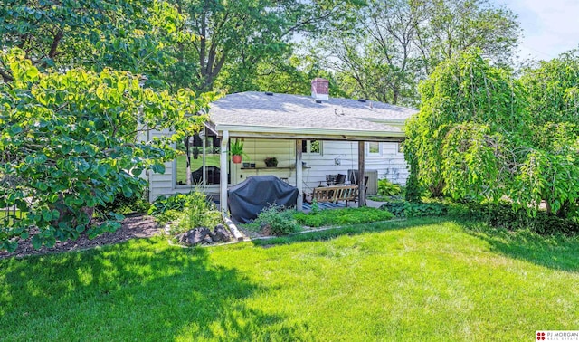 1439 S 123rd St, Omaha, NE 68144 - back of property featuring a lawn, a chimney, and a patio