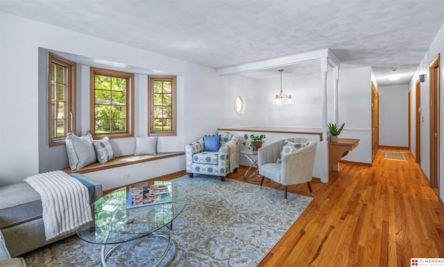 1439 S 123rd St, Omaha, NE 68144 - living area featuring wood finished floors, a chandelier, and baseboards
