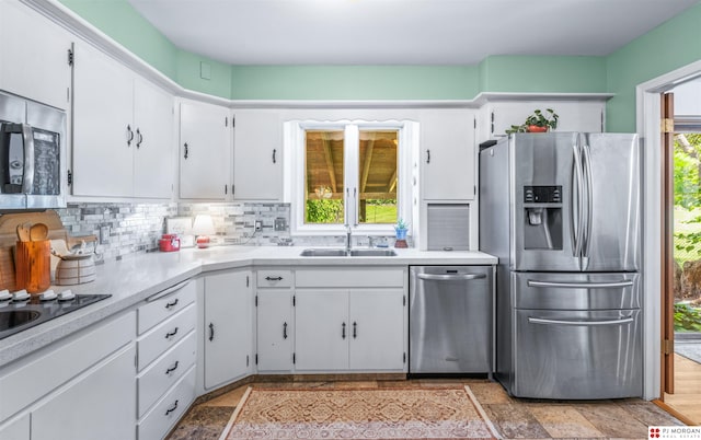 1439 S 123rd St, Omaha, NE 68144 - kitchen featuring stainless steel appliances, a sink, white cabinetry, and decorative backsplash