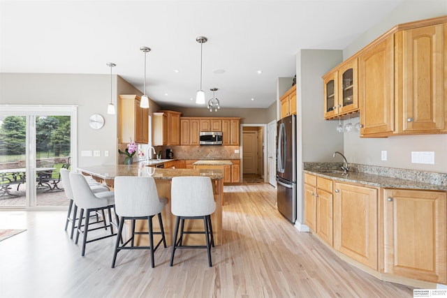 13303 Cuming St, Omaha, NE 68154 - kitchen with stainless steel appliances, a sink, a peninsula, light wood-style flooring, and recessed lighting