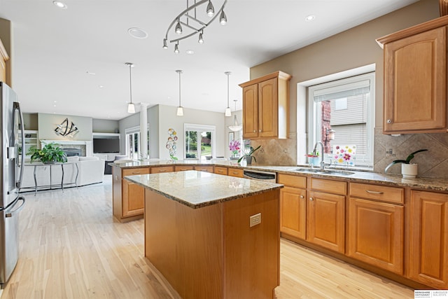 13303 Cuming St, Omaha, NE 68154 - kitchen featuring a sink, a peninsula, light wood finished floors, open floor plan, and light stone countertops