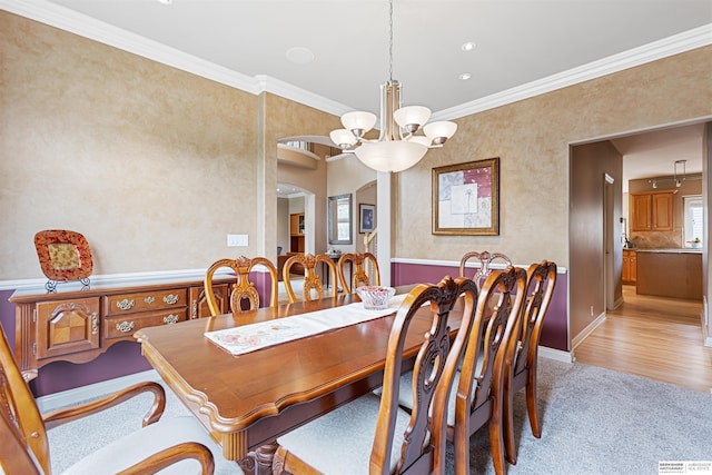 13303 Cuming St, Omaha, NE 68154 - dining space with a chandelier, ornamental molding, arched walkways, and light colored carpet