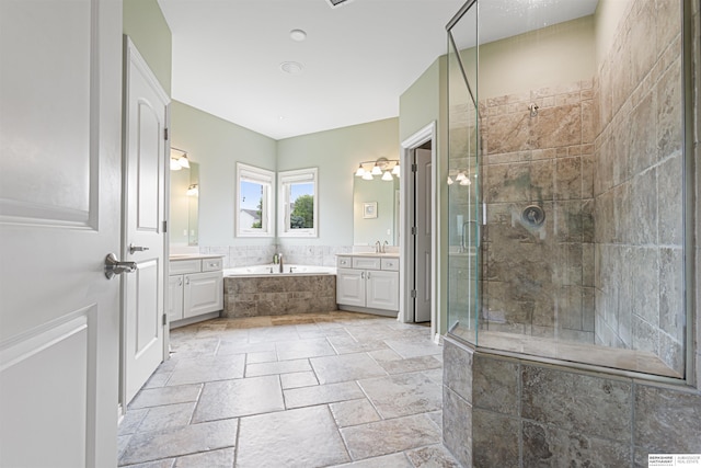 13303 Cuming St, Omaha, NE 68154 - bathroom with two vanities, a garden tub, a stall shower, and stone tile flooring