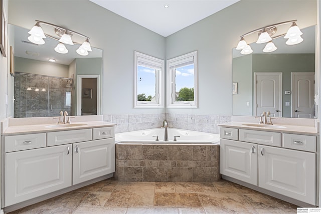 13303 Cuming St, Omaha, NE 68154 - full bathroom with two vanities, a garden tub, tiled shower, and stone finish floors