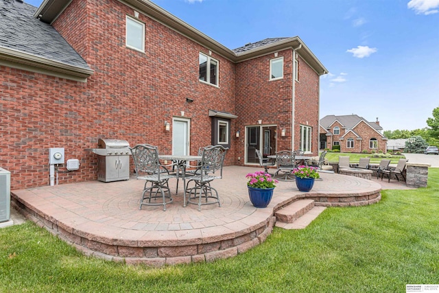 13303 Cuming St, Omaha, NE 68154 - rear view of house with a patio area, a lawn, brick siding, central AC, and outdoor dining space