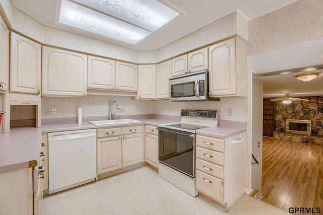 5617 S 93rd St, Omaha, NE 68127 - kitchen featuring white appliances, a sink, ceiling fan, light countertops, and light wood-style floors