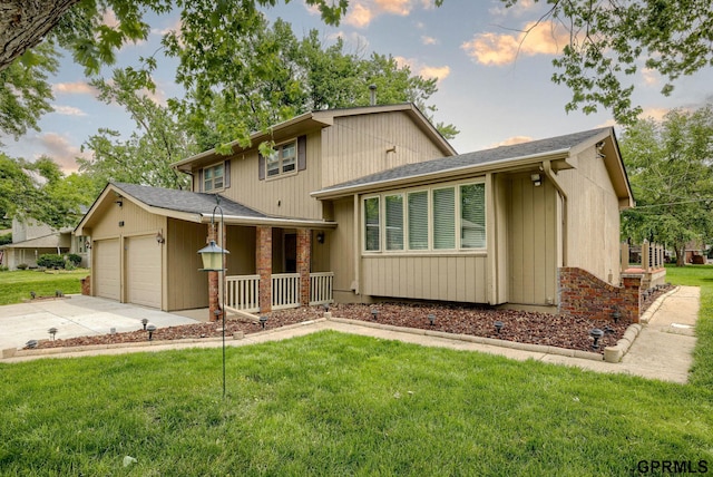 5617 S 93rd St, Omaha, NE 68127 - view of front of home featuring covered porch, an attached garage, a front lawn, and concrete driveway
