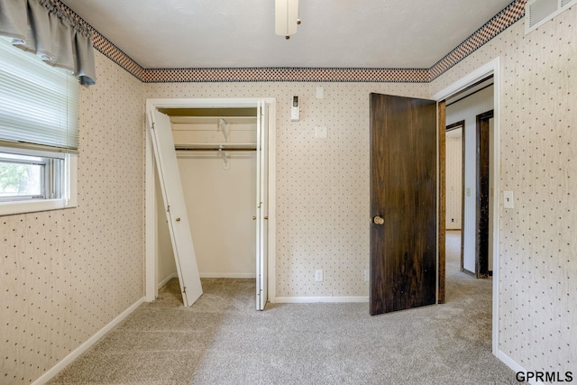 5617 S 93rd St, Omaha, NE 68127 - unfurnished bedroom featuring carpet flooring, wallpapered walls, baseboards, and a closet