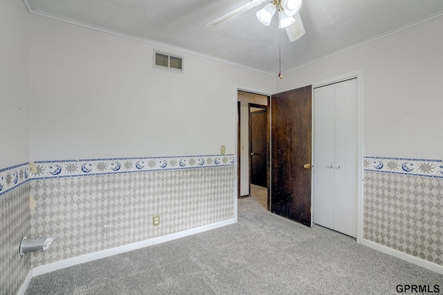 5617 S 93rd St, Omaha, NE 68127 - unfurnished room featuring wallpapered walls, carpet flooring, wainscoting, a ceiling fan, and baseboards