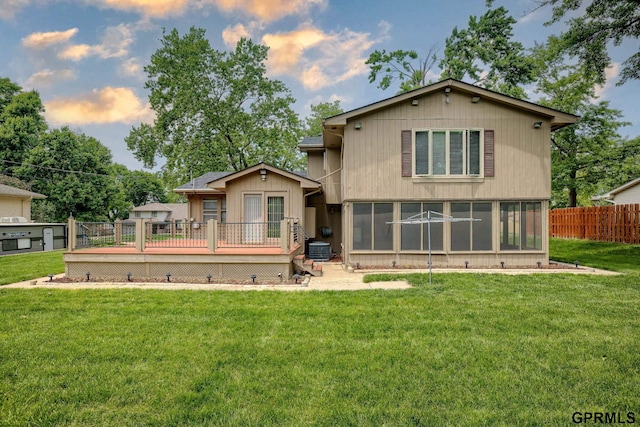 5617 S 93rd St, Omaha, NE 68127 - back of property at dusk featuring a deck, a sunroom, and central AC unit