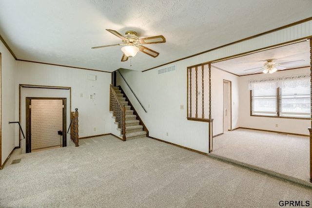 5617 S 93rd St, Omaha, NE 68127 - unfurnished living room featuring a ceiling fan, crown molding, stairway, carpet flooring, and baseboards