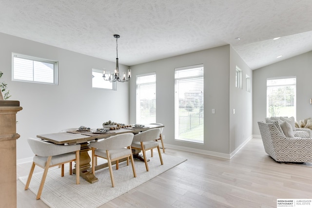 19920 Tyler St, Omaha, NE 68135 - dining space featuring a chandelier, a textured ceiling, light wood-style flooring, healthy amount of natural light, and baseboards