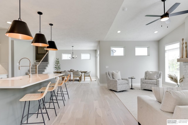 19920 Tyler St, Omaha, NE 68135 - living room with light wood-style floors, ceiling fan, recessed lighting, baseboards, and stairway