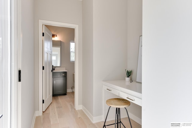 19920 Tyler St, Omaha, NE 68135 - hall featuring light wood-style floors, baseboards, and a sink