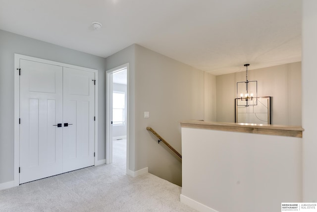 19920 Tyler St, Omaha, NE 68135 - hallway featuring an upstairs landing, a chandelier, carpet flooring, and baseboards