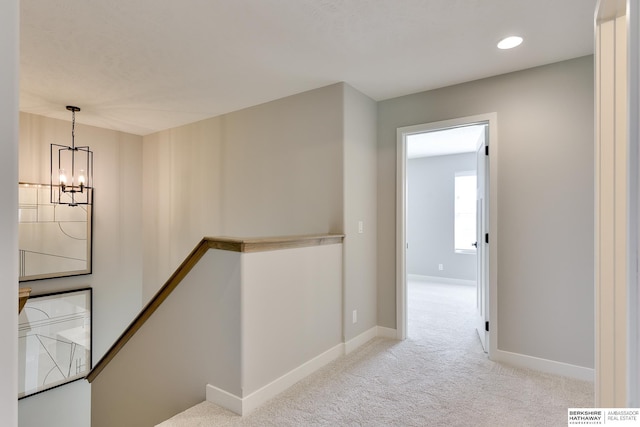 19920 Tyler St, Omaha, NE 68135 - corridor featuring a chandelier, carpet flooring, baseboards, an upstairs landing, and recessed lighting