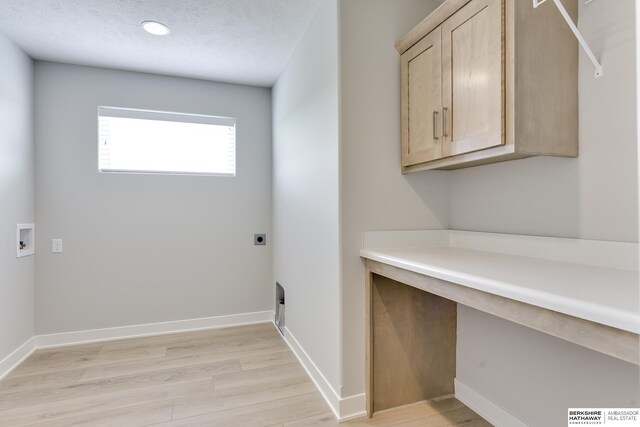 19920 Tyler St, Omaha, NE 68135 - laundry area featuring cabinet space, light wood-style flooring, electric dryer hookup, and hookup for a washing machine