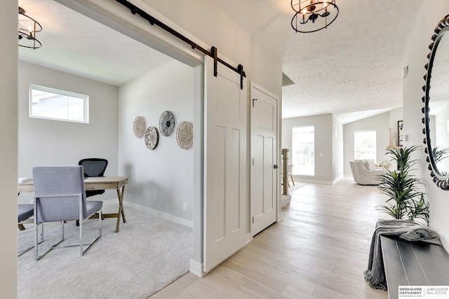 19920 Tyler St, Omaha, NE 68135 - home office featuring a barn door, plenty of natural light, baseboards, and a textured ceiling