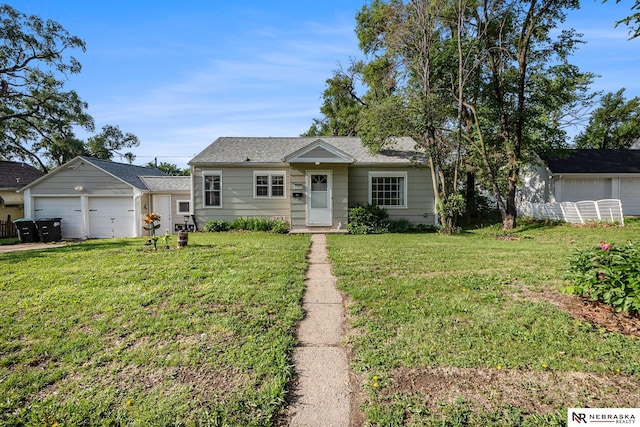 6021 Frederick St, Omaha, NE 68106 - bungalow featuring a front lawn, an attached garage, and an outdoor structure