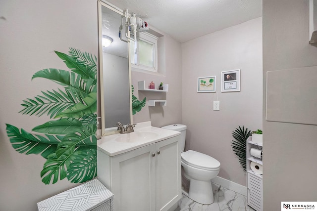 6021 Frederick St, Omaha, NE 68106 - bathroom with vanity, toilet, marble look tiles, and baseboards