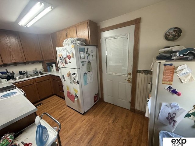 608 E Fillmore Ave, Dewitt, NE 68341 - kitchen with white appliances, a sink, light wood finished floors, and light countertops