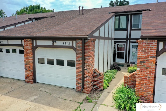 4115 N 45th Street Ct, Lincoln, NE 68504 - view of front facade with brick siding, roof with shingles, and driveway