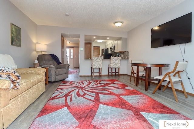 4115 N 45th Street Ct, Lincoln, NE 68504 - living room featuring wood finished floors, a textured ceiling, and baseboards