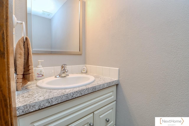 4115 N 45th Street Ct, Lincoln, NE 68504 - bathroom featuring vanity and a textured wall