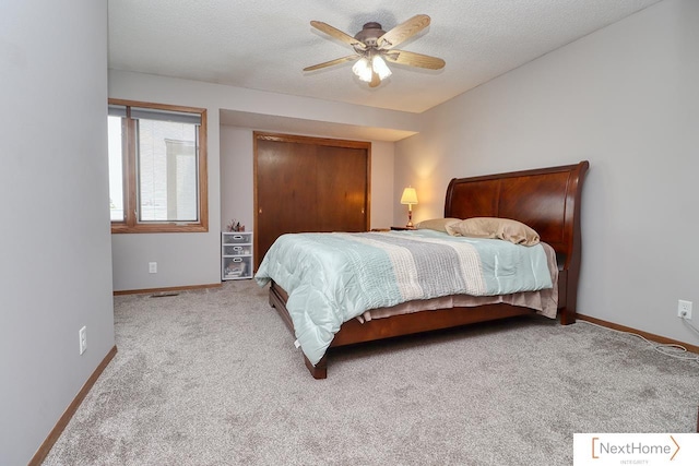 4115 N 45th Street Ct, Lincoln, NE 68504 - carpeted bedroom with baseboards, a closet, a textured ceiling, and a ceiling fan
