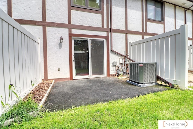 4115 N 45th Street Ct, Lincoln, NE 68504 - view of exterior entry featuring central air condition unit, stucco siding, and a patio