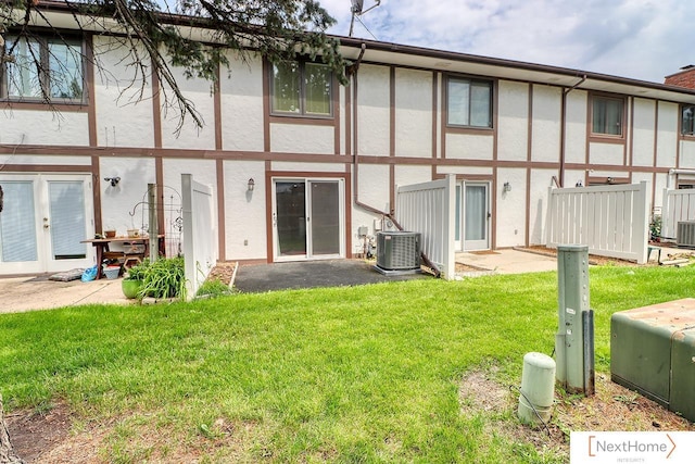 4115 N 45th Street Ct, Lincoln, NE 68504 - rear view of house featuring stucco siding, central AC, and a lawn