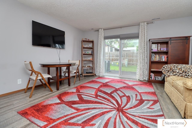 4115 N 45th Street Ct, Lincoln, NE 68504 - living area with a textured ceiling, wood finished floors, and baseboards