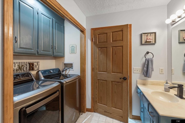 918 N 150th St, Omaha, NE 68154 - washroom with washer and clothes dryer, a sink, a textured ceiling, baseboards, and light tile patterned floors